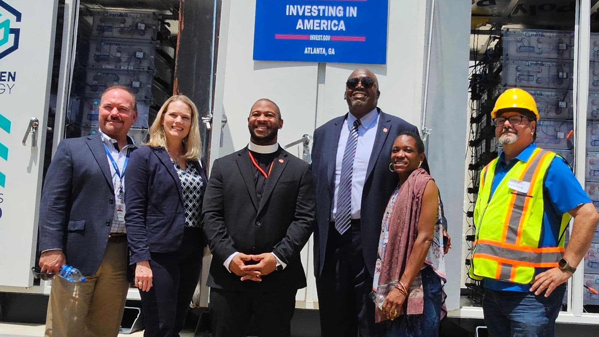 Municipal professionals and community members collaborating around a table outdoors